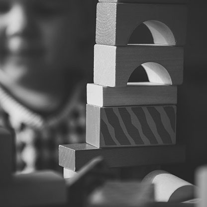 A child constructing a tower out of building blocks